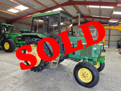 Side view of a green JOHN DEERE 1640 with red SOLD writing