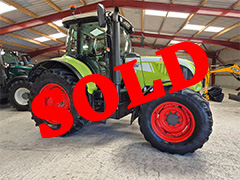 Side view of the green CLAAS 610c ARION