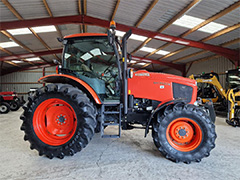 Side view of the orange Kubota M135