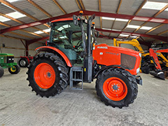 Side view of the orange KUBOTA M95GX-3